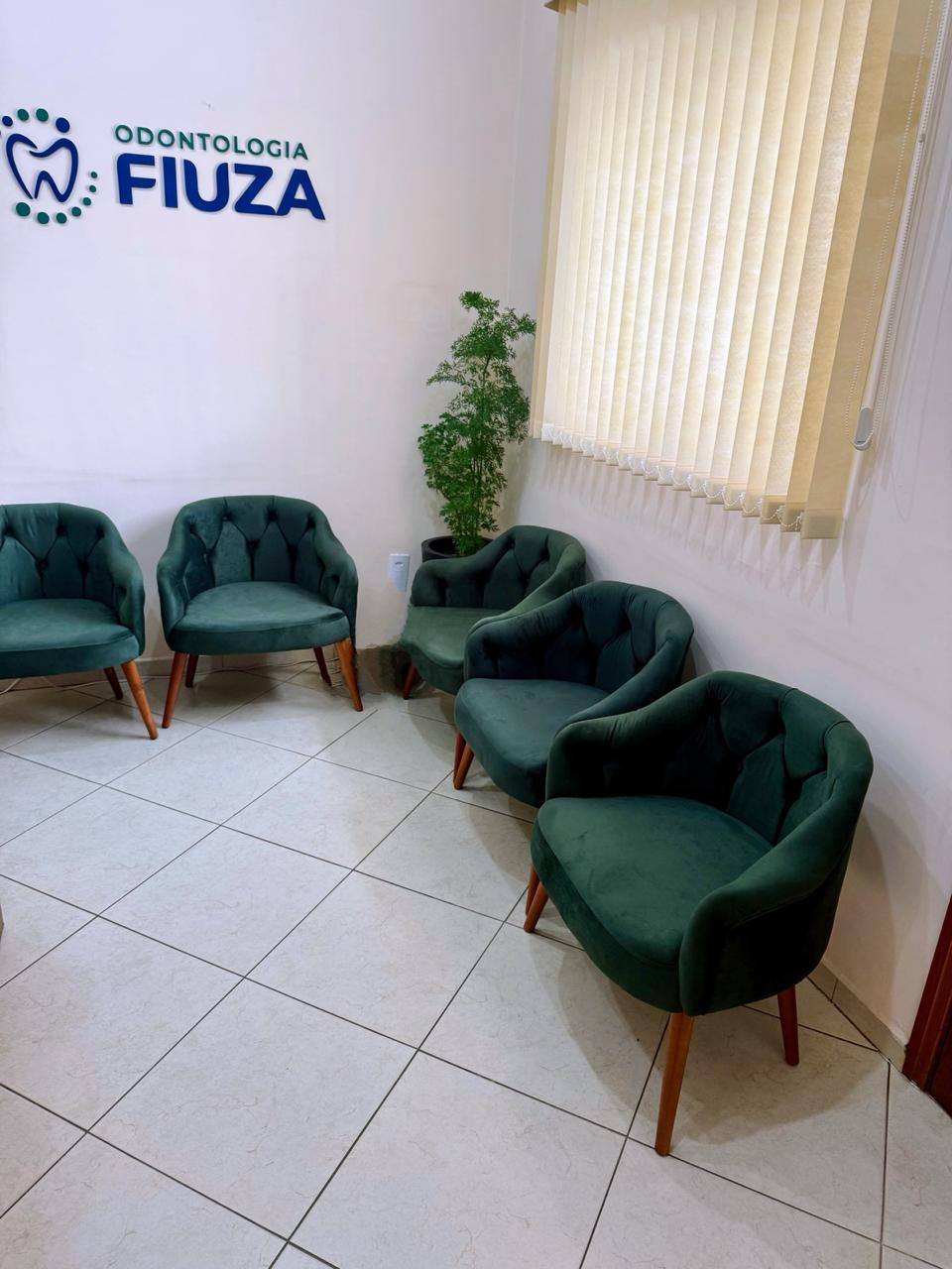 Recepção da Odontologia Fiuza com poltronas em verde petróleo